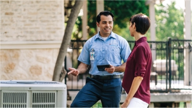 Aire Serv tech explaining HVAC system to customer.